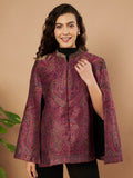 Woman wearing the Zaynah Moonlight Kaani Cape Jacket with intricate paisley Kaani weave and elegant structured cape silhouette.
