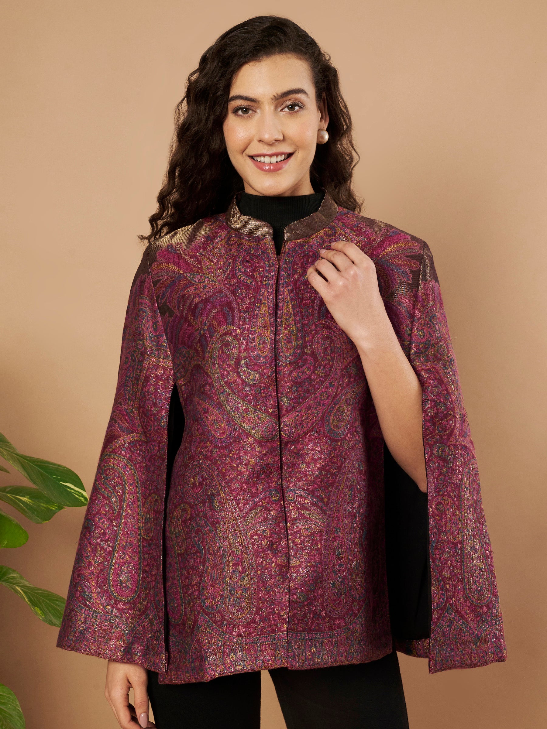 Woman wearing the Zaynah Moonlight Kaani Cape Jacket with intricate paisley Kaani weave and elegant structured cape silhouette.
