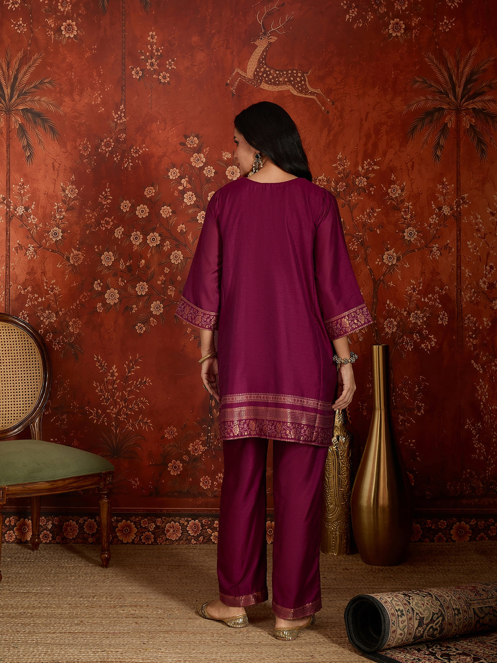 Woman wearing the Rangmahal Zari Woven Co-Ord Set in a rich wine hue featuring intricate zari-woven chevron motifs, decorative borders, and matching trousers for festive and contemporary occasions.
