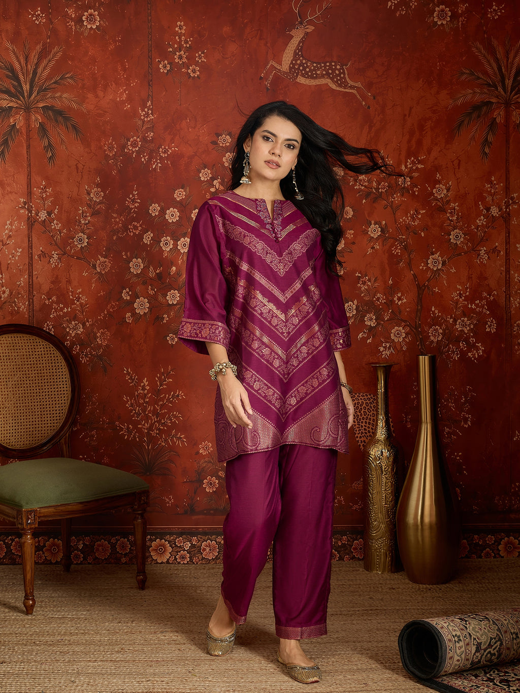 Woman wearing the Rangmahal Zari Woven Co-Ord Set in a rich wine hue featuring intricate zari-woven chevron motifs, decorative borders, and matching trousers for festive and contemporary occasions.
