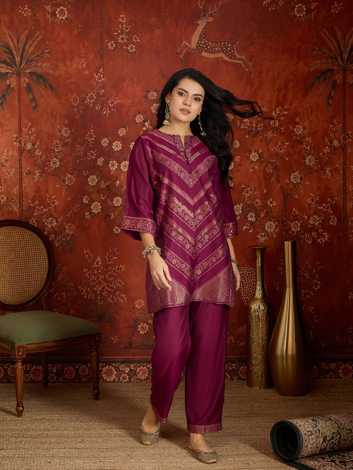 Woman wearing the Rangmahal Zari Woven Co-Ord Set in a rich wine hue featuring intricate zari-woven chevron motifs, decorative borders, and matching trousers for festive and contemporary occasions.