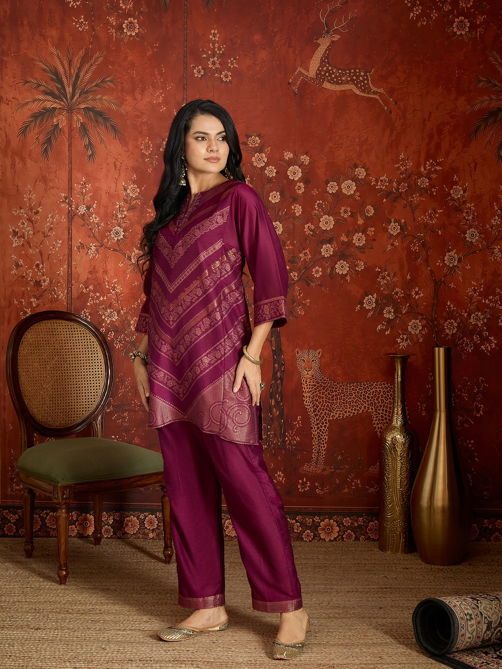 Woman wearing the Rangmahal Zari Woven Co-Ord Set in a rich wine hue featuring intricate zari-woven chevron motifs, decorative borders, and matching trousers for festive and contemporary occasions.