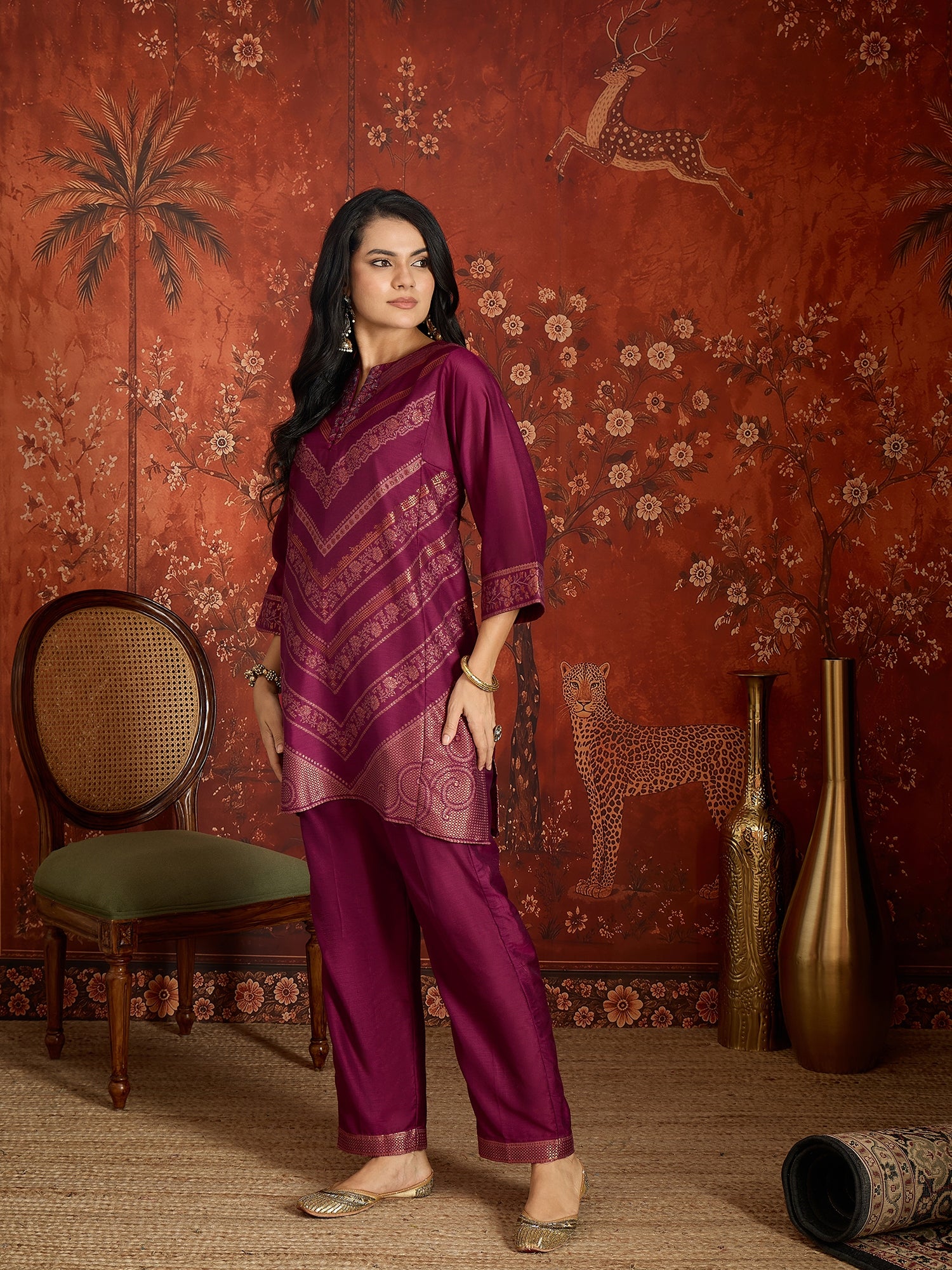 Woman wearing the Rangmahal Zari Woven Co-Ord Set in a rich wine hue featuring intricate zari-woven chevron motifs, decorative borders, and matching trousers for festive and contemporary occasions.