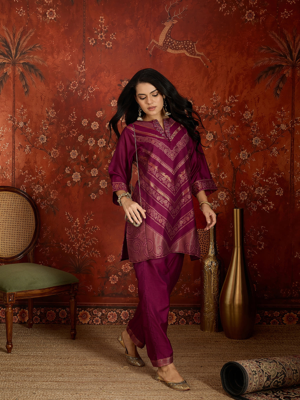 Woman wearing the Rangmahal Zari Woven Co-Ord Set in a rich wine hue featuring intricate zari-woven chevron motifs, decorative borders, and matching trousers for festive and contemporary occasions.