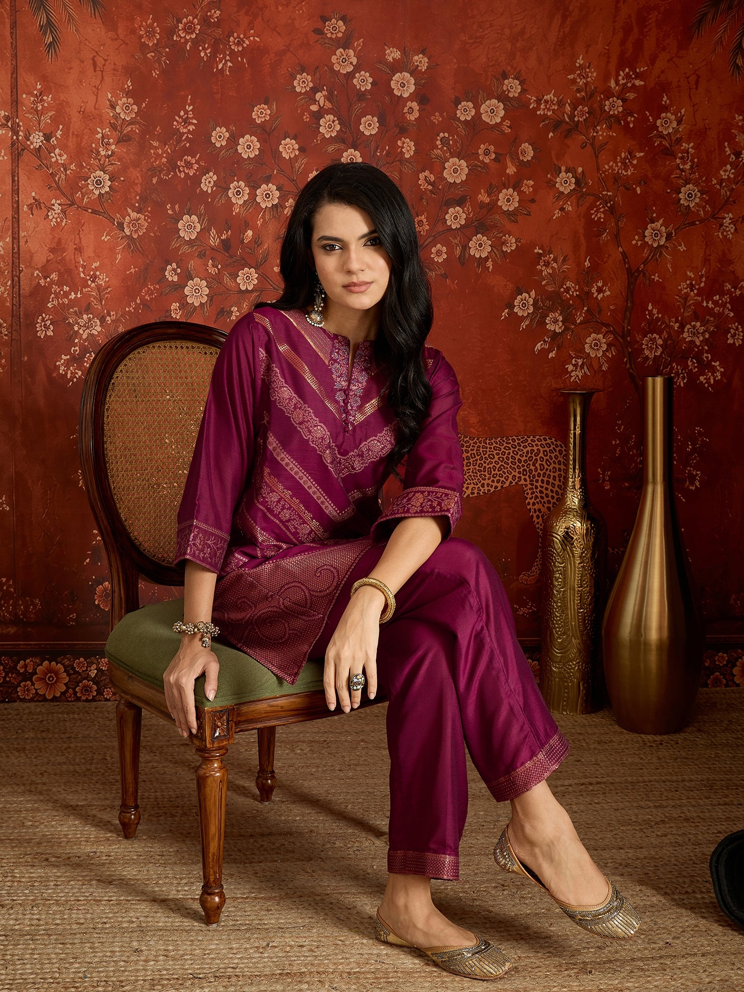 Woman wearing the Rangmahal Zari Woven Co-Ord Set in a rich wine hue featuring intricate zari-woven chevron motifs, decorative borders, and matching trousers for festive and contemporary occasions.