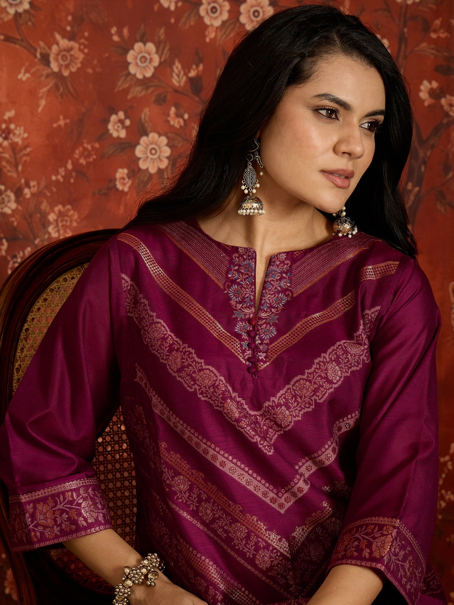 Woman wearing the Rangmahal Zari Woven Co-Ord Set in a rich wine hue featuring intricate zari-woven chevron motifs, decorative borders, and matching trousers for festive and contemporary occasions.