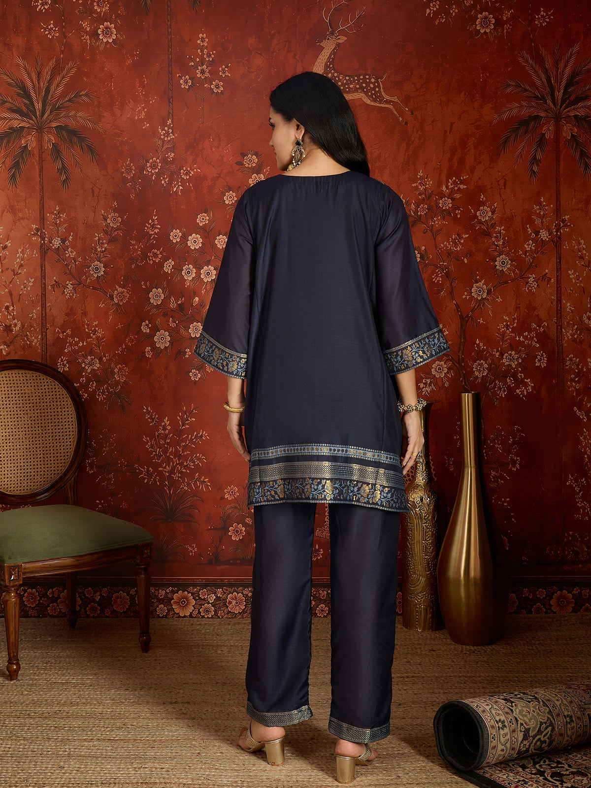 Woman wearing the Neelzar Zari Woven Co-Ord Set in navy blue featuring intricate zari-woven motifs and matching trousers, styled for festive and contemporary occasions.