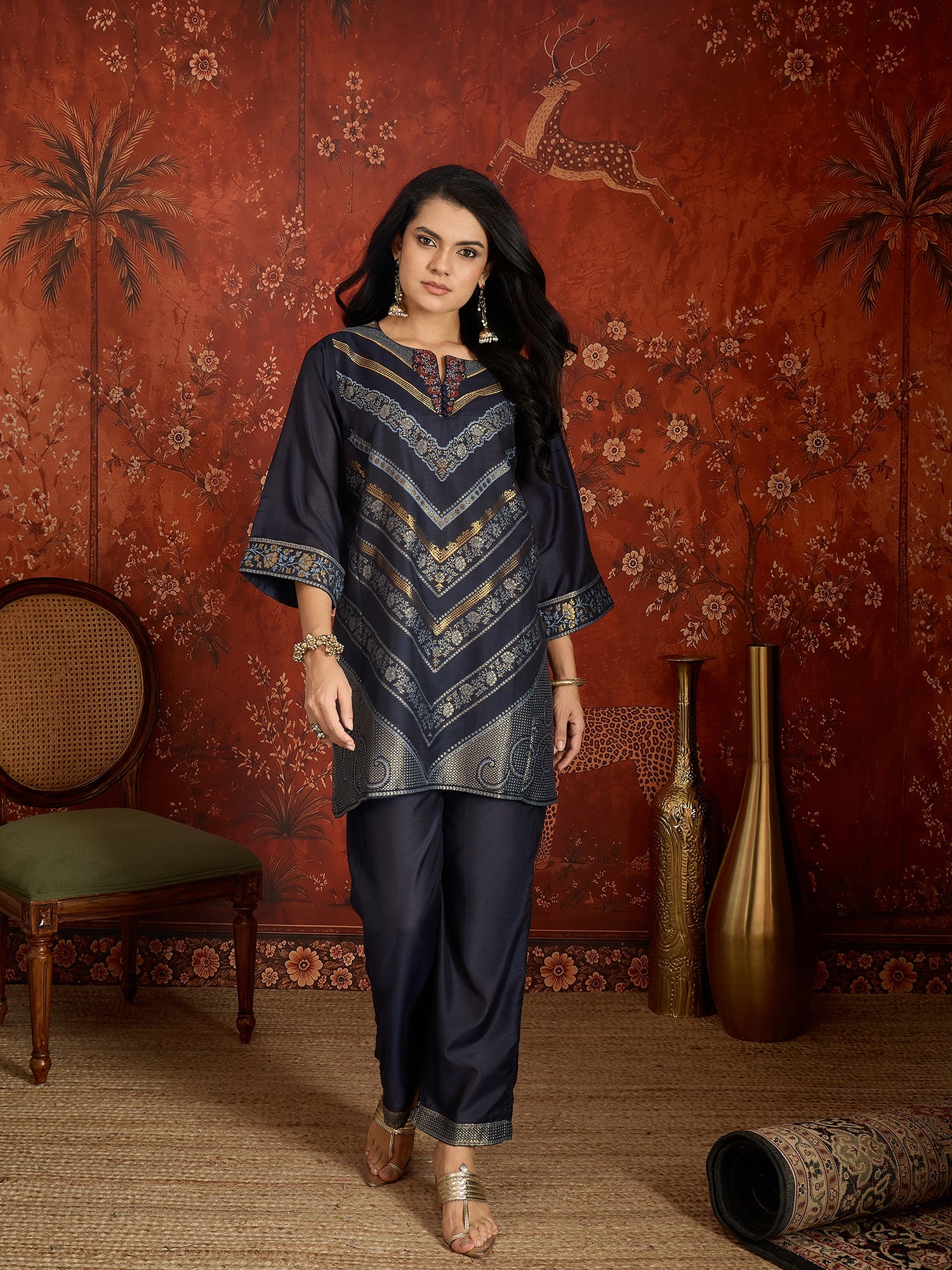 Woman wearing the Neelzar Zari Woven Co-Ord Set in navy blue featuring intricate zari-woven motifs and matching trousers, styled for festive and contemporary occasions.