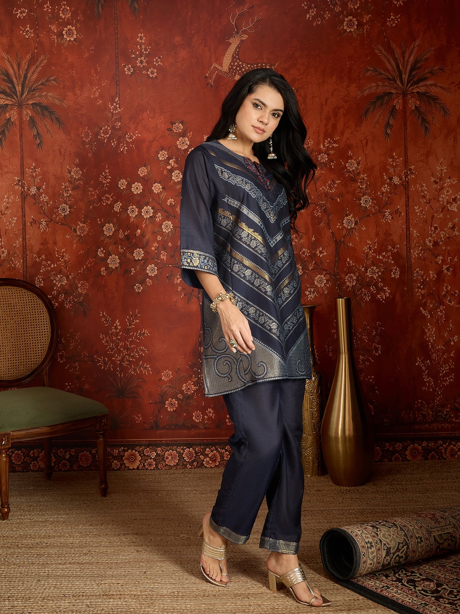 Woman wearing the Neelzar Zari Woven Co-Ord Set in navy blue featuring intricate zari-woven motifs and matching trousers, styled for festive and contemporary occasions.