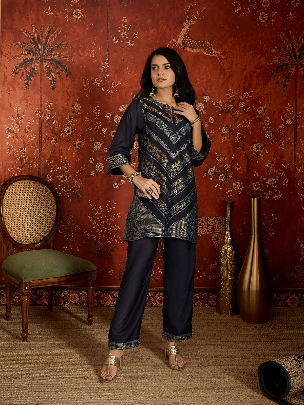 Woman wearing the Neelzar Zari Woven Co-Ord Set in navy blue featuring intricate zari-woven motifs and matching trousers, styled for festive and contemporary occasions.