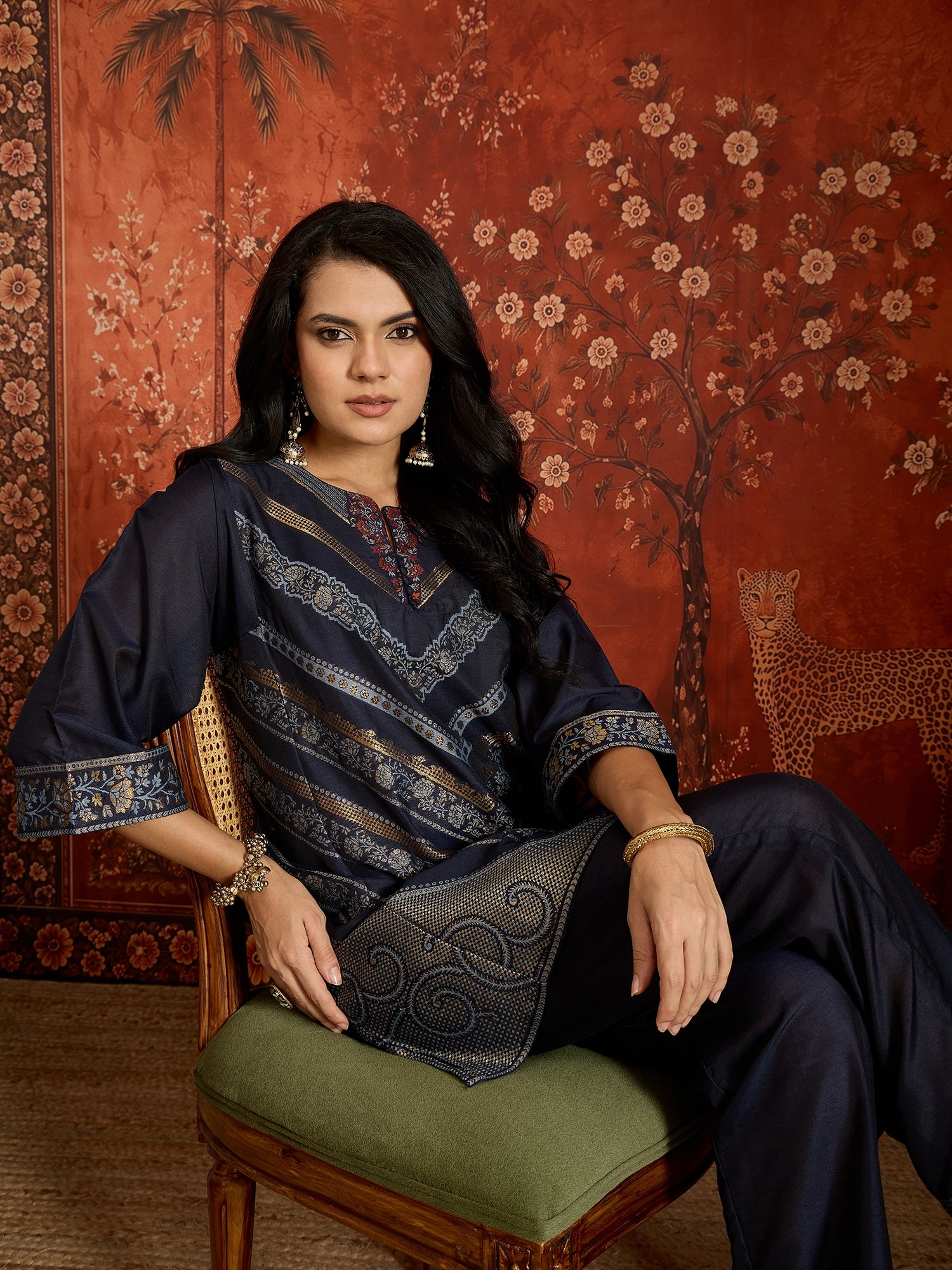 Woman wearing the Neelzar Zari Woven Co-Ord Set in navy blue featuring intricate zari-woven motifs and matching trousers, styled for festive and contemporary occasions.