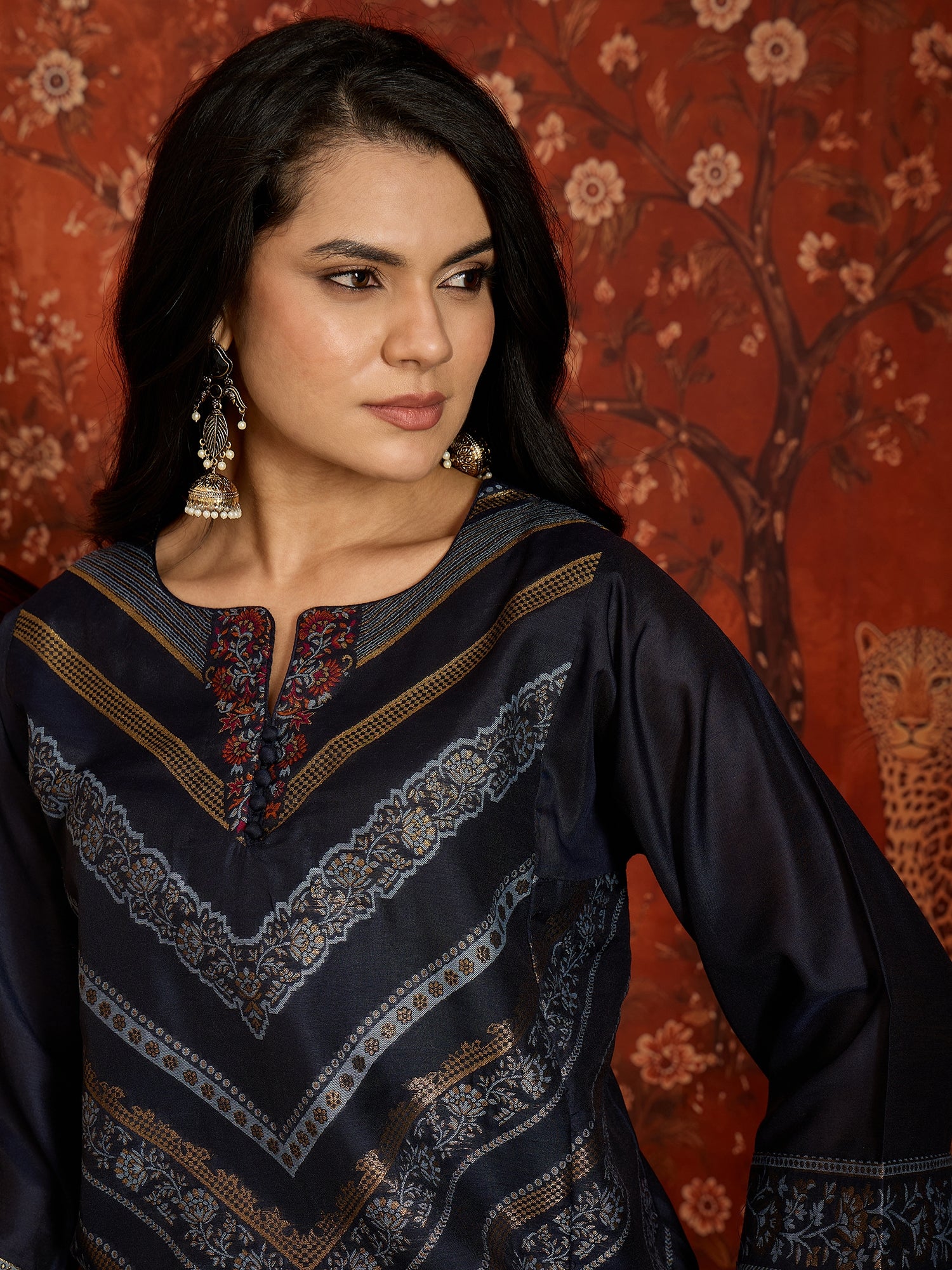 Woman wearing the Neelzar Zari Woven Co-Ord Set in navy blue featuring intricate zari-woven motifs and matching trousers, styled for festive and contemporary occasions.