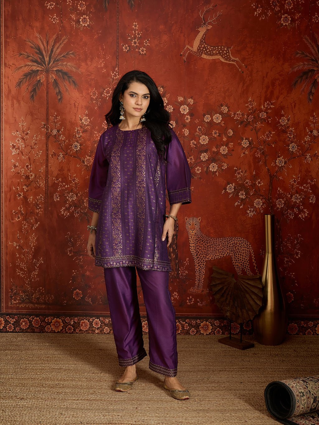 Woman wearing the Gulnaar Zari Woven Co-Ord Set in royal purple featuring intricate zari-woven motifs and matching trousers, styled for festive occasions and elegant contemporary wear.
