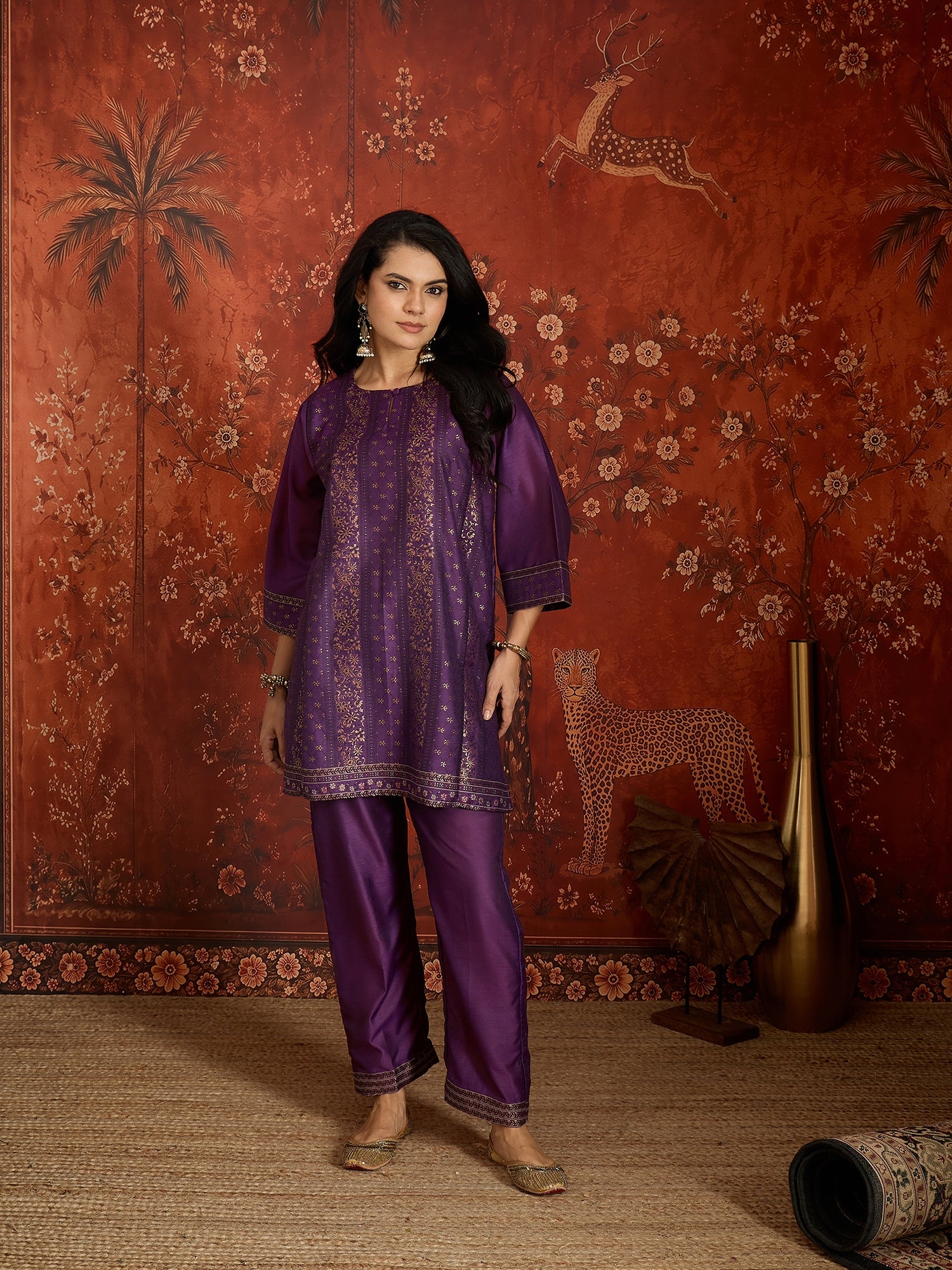 Woman wearing the Gulnaar Zari Woven Co-Ord Set in royal purple featuring intricate zari-woven motifs and matching trousers, styled for festive occasions and elegant contemporary wear.