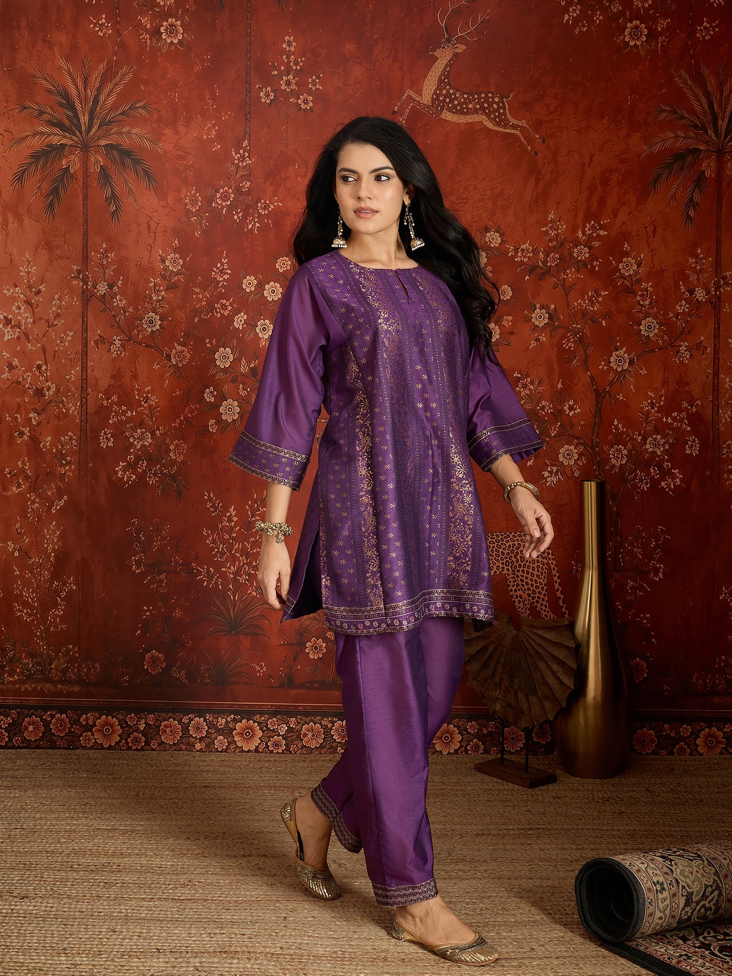 Woman wearing the Gulnaar Zari Woven Co-Ord Set in royal purple featuring intricate zari-woven motifs and matching trousers, styled for festive occasions and elegant contemporary wear.
