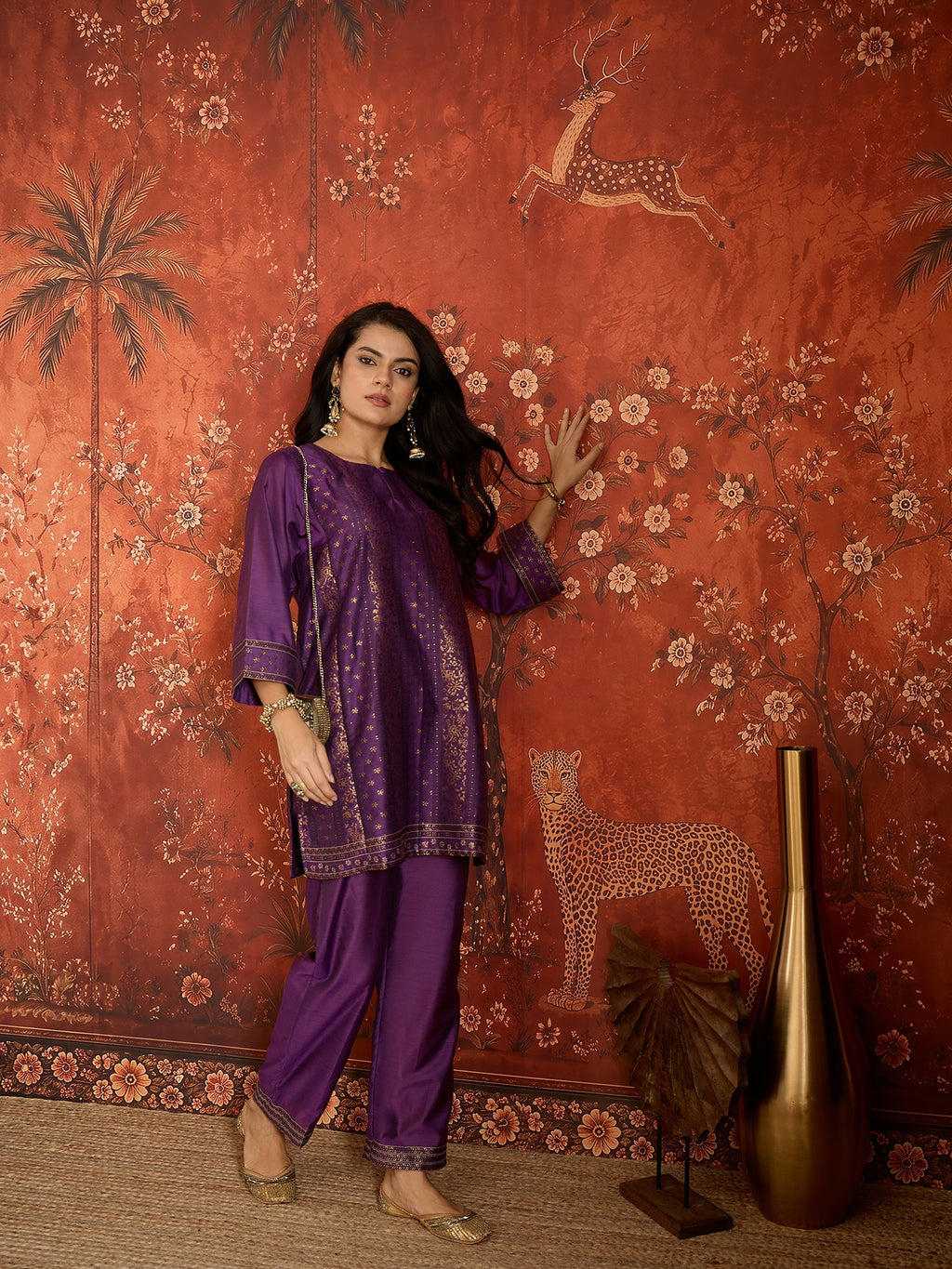Woman wearing the Gulnaar Zari Woven Co-Ord Set in royal purple featuring intricate zari-woven motifs and matching trousers, styled for festive occasions and elegant contemporary wear.