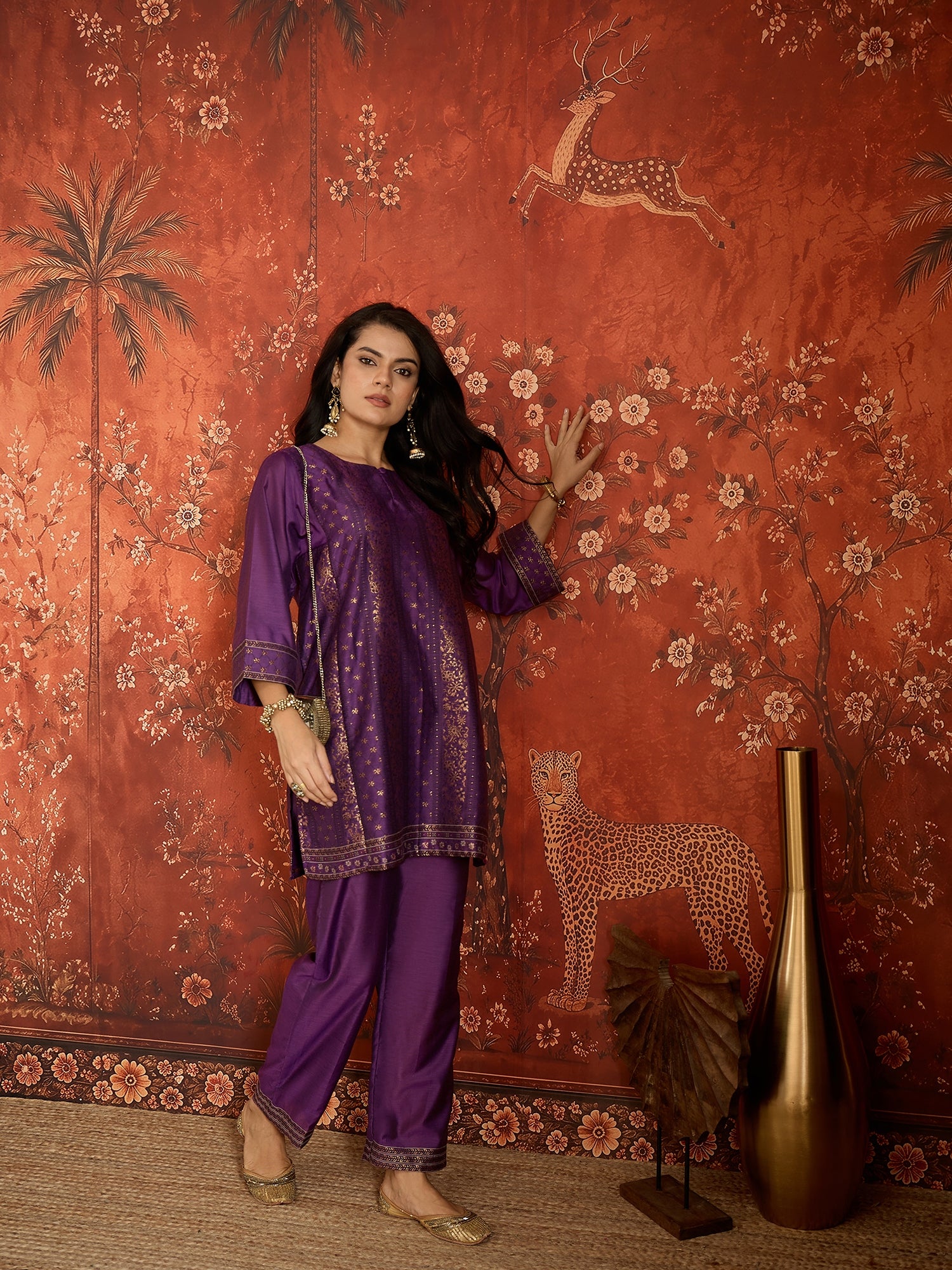 Woman wearing the Gulnaar Zari Woven Co-Ord Set in royal purple featuring intricate zari-woven motifs and matching trousers, styled for festive occasions and elegant contemporary wear.