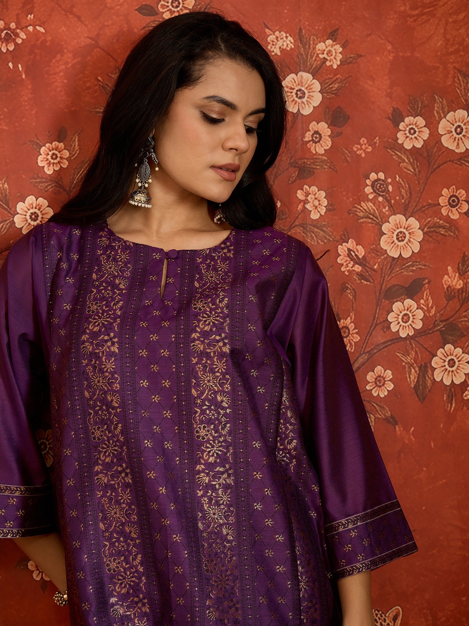 Woman wearing the Gulnaar Zari Woven Co-Ord Set in royal purple featuring intricate zari-woven motifs and matching trousers, styled for festive occasions and elegant contemporary wear.