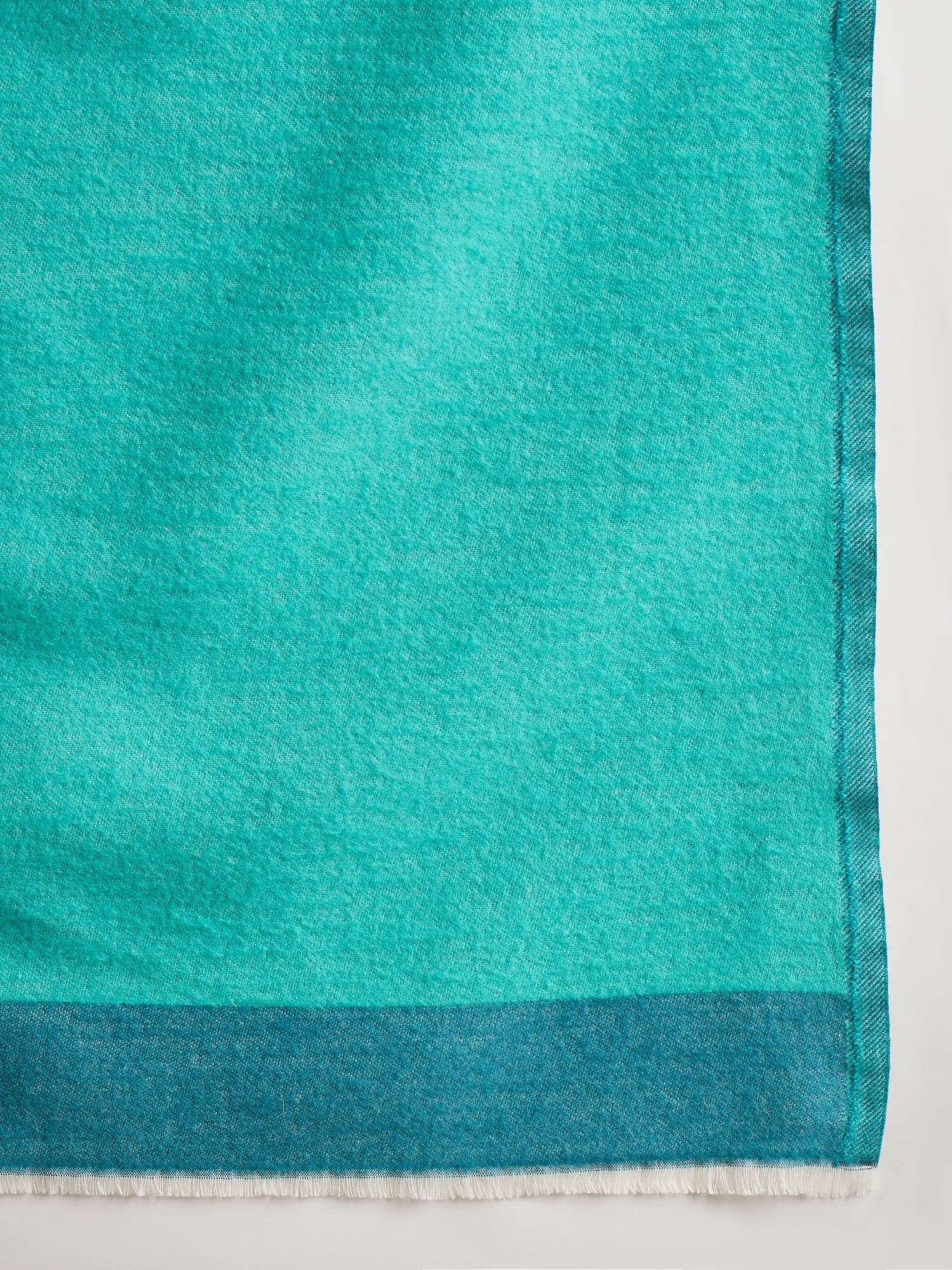 Reversible aqua blue and teal blue cashmere-feel stole for women with a soft drape and elegant dual-tone design, styled in two different ways.