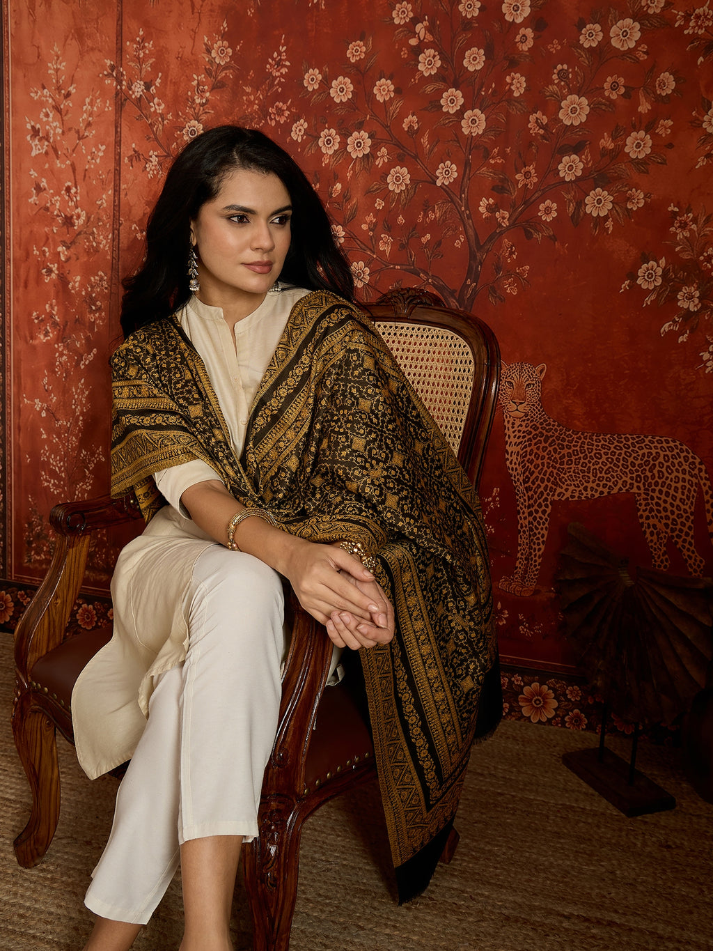 Reversible mustard and black woven stole for women featuring intricate heritage-inspired jacquard motifs and elegant reversible styling.