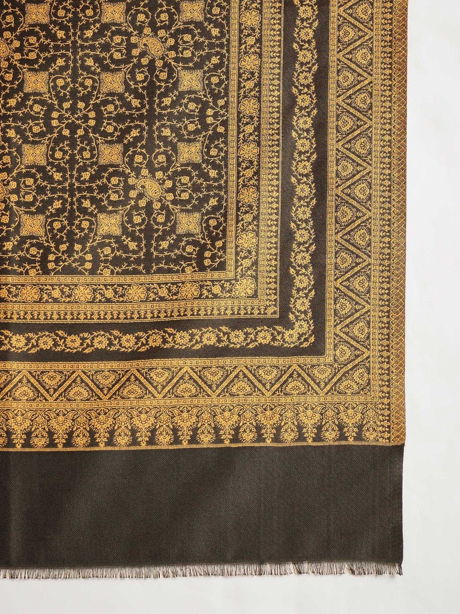 Reversible mustard and black woven stole for women featuring intricate heritage-inspired jacquard motifs and elegant reversible styling.
