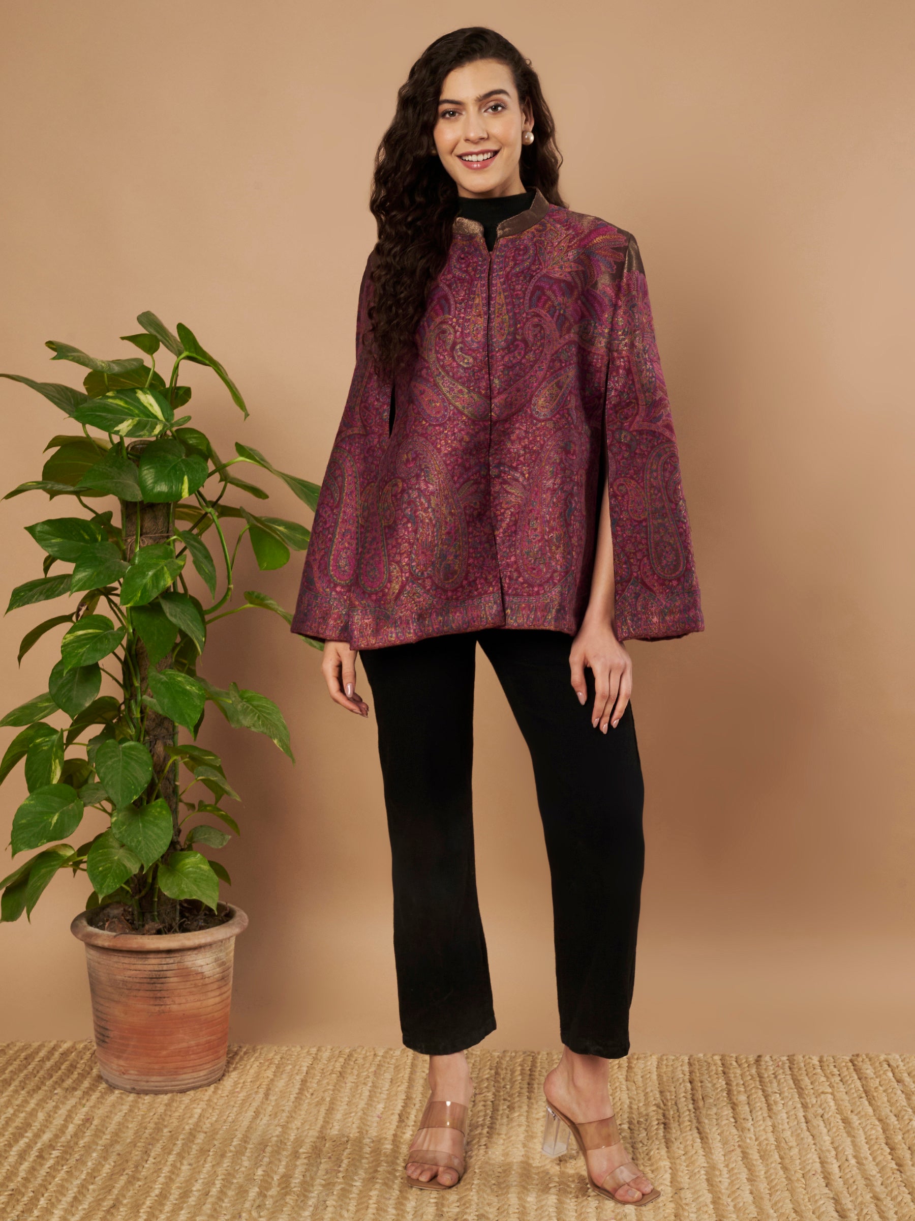 Woman wearing the Zaynah Moonlight Kaani Cape Jacket with intricate paisley Kaani weave and elegant structured cape silhouette.