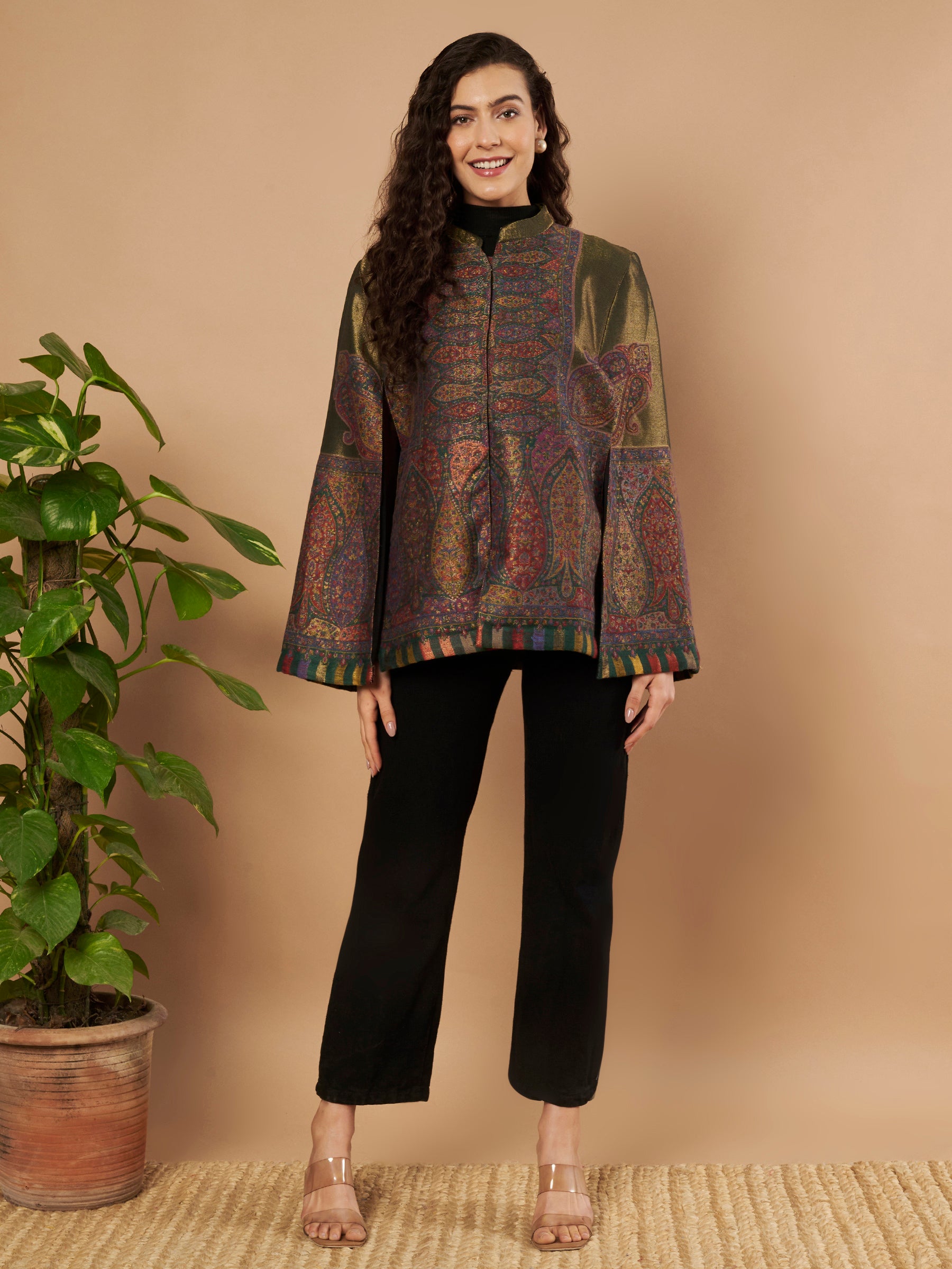 Woman wearing the Falak Moonlight Kaani Cape Jacket with intricate Kashmiri woven paisley motifs and elegant cape silhouette.
