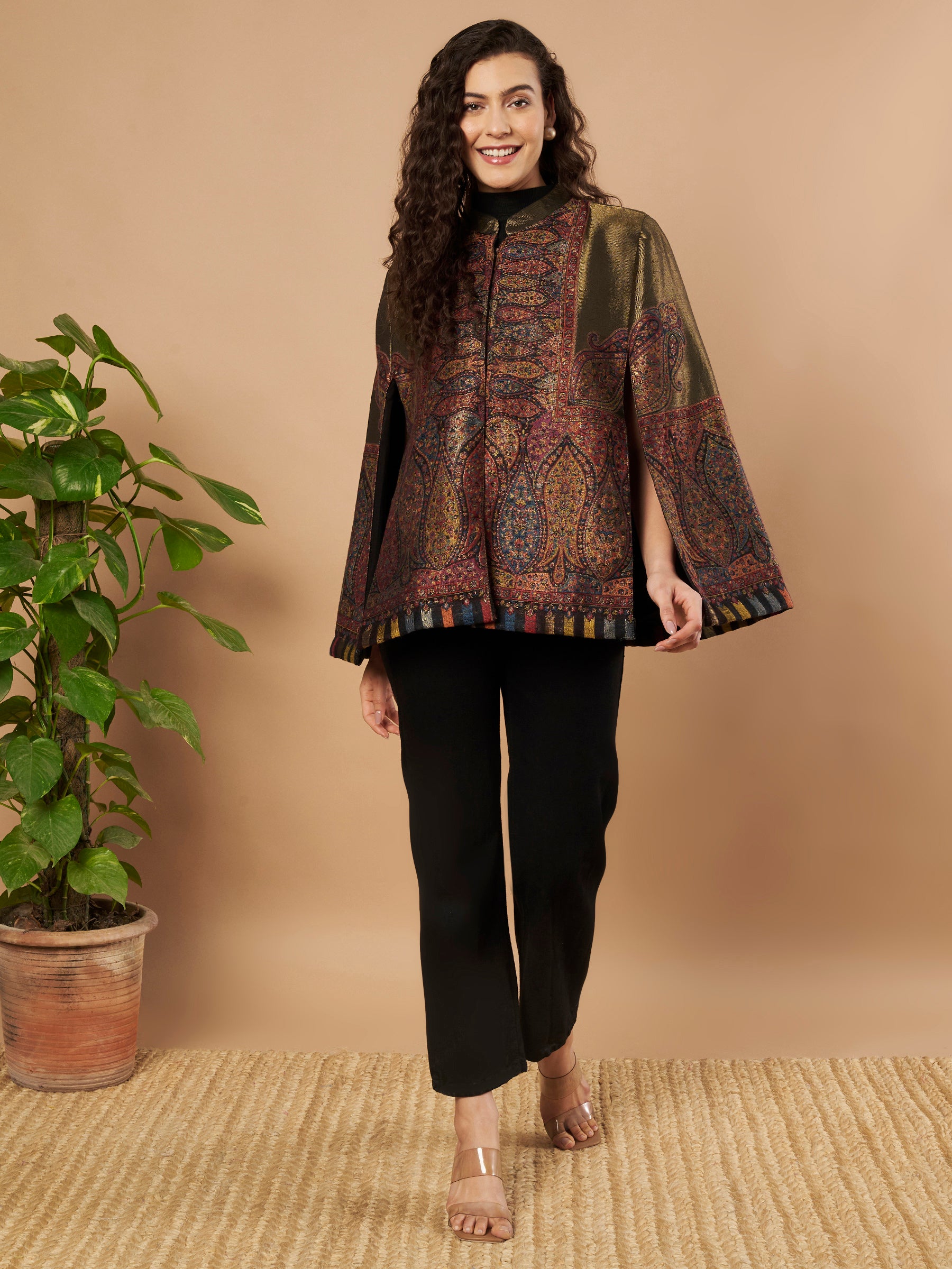 Woman wearing the Shaza Moonlight Kaani Cape Jacket with intricate Kashmiri paisley weave and elegant structured cape silhouette.