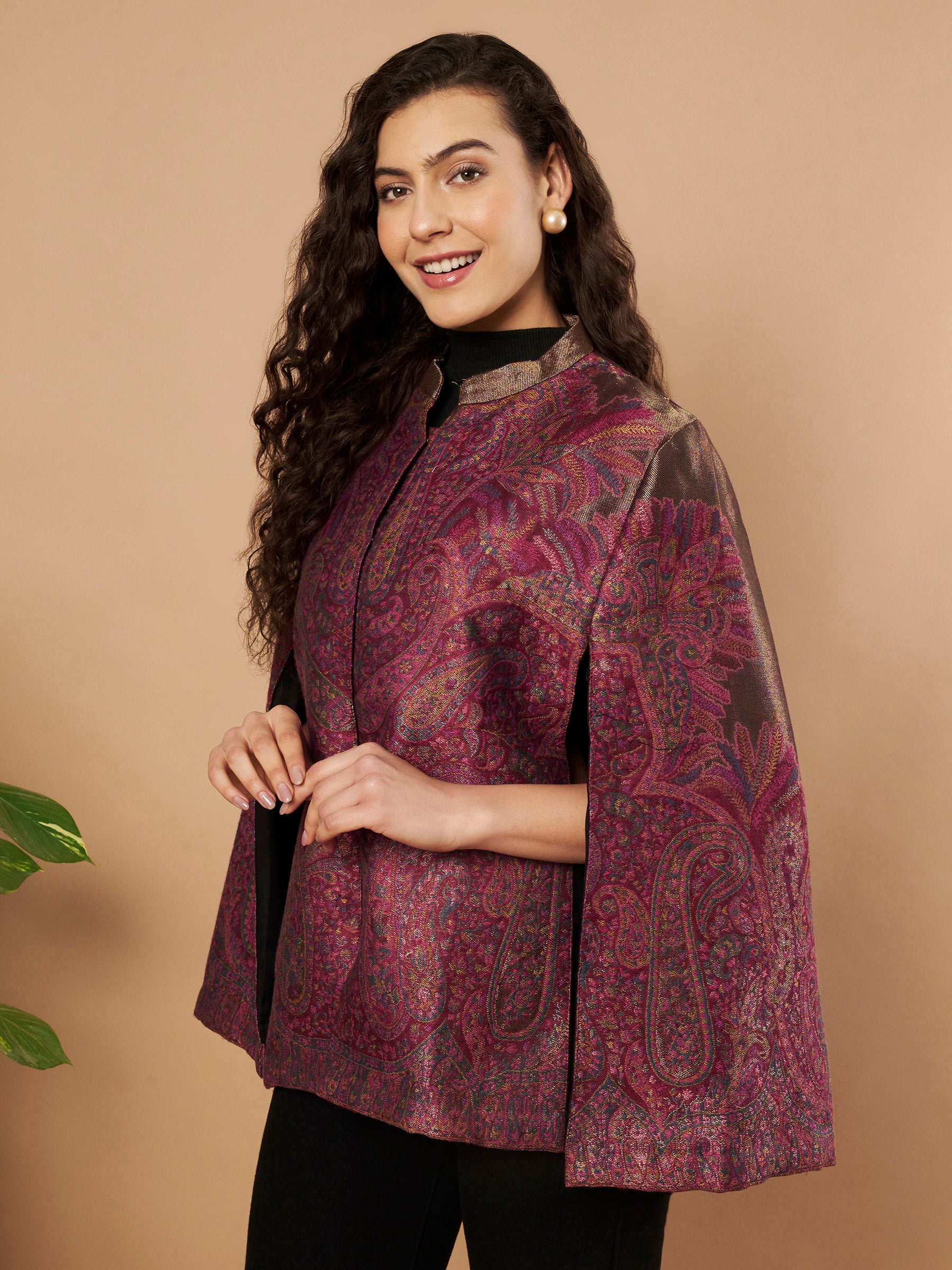 Woman wearing the Zaynah Moonlight Kaani Cape Jacket with intricate paisley Kaani weave and elegant structured cape silhouette.