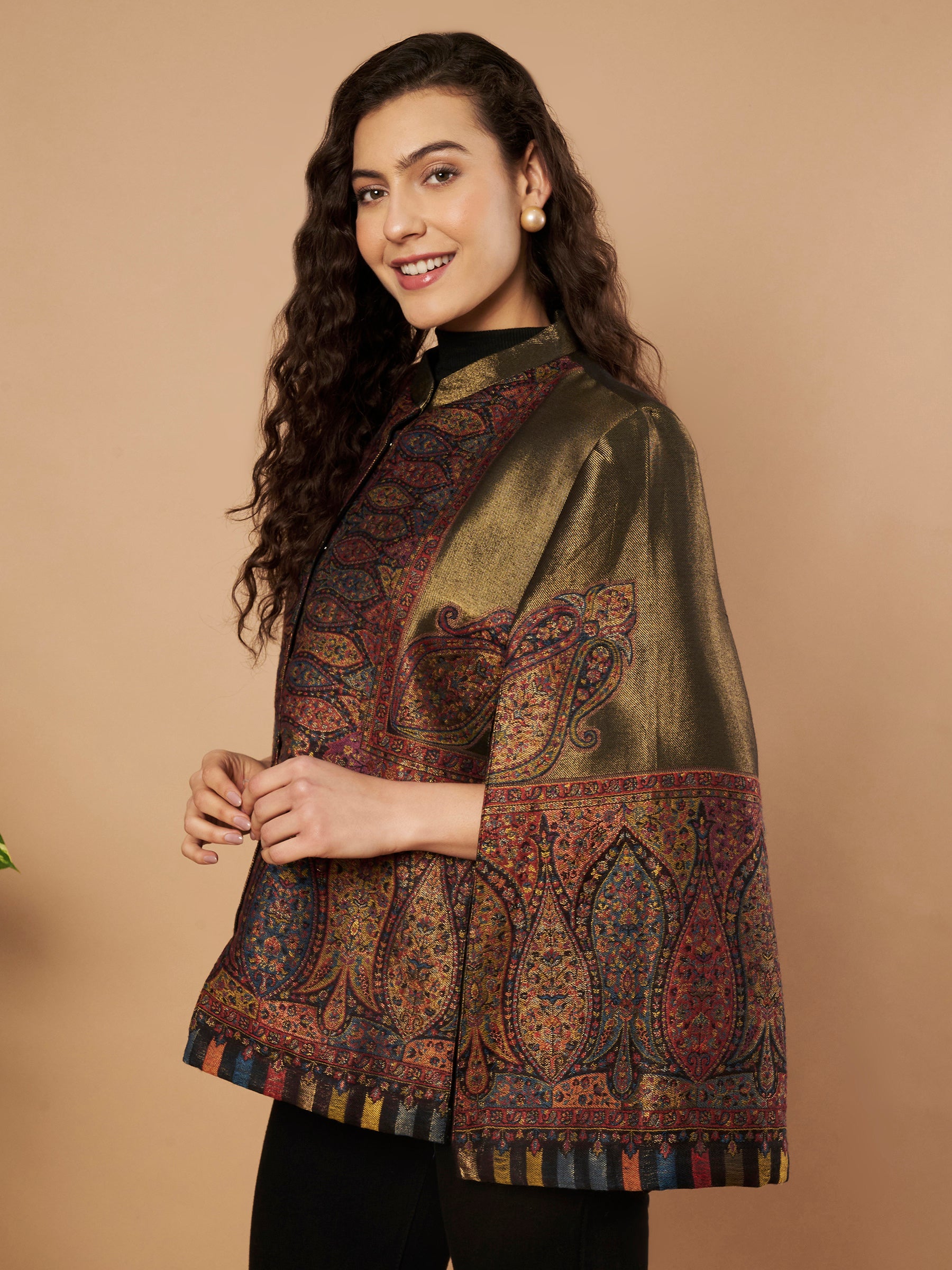 Woman wearing the Shaza Moonlight Kaani Cape Jacket with intricate Kashmiri paisley weave and elegant structured cape silhouette.