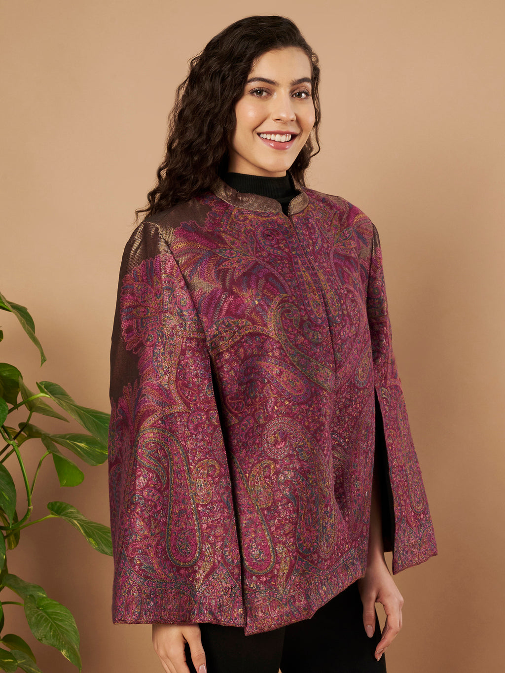 Woman wearing the Zaynah Moonlight Kaani Cape Jacket with intricate paisley Kaani weave and elegant structured cape silhouette.