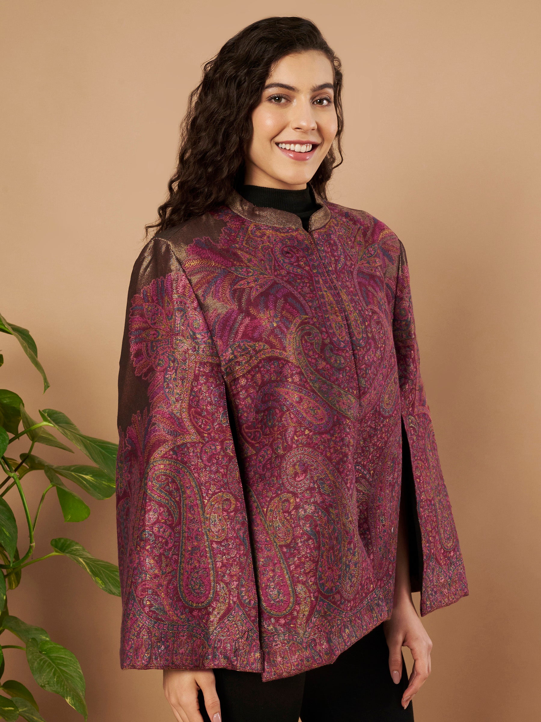 Woman wearing the Zaynah Moonlight Kaani Cape Jacket with intricate paisley Kaani weave and elegant structured cape silhouette.
