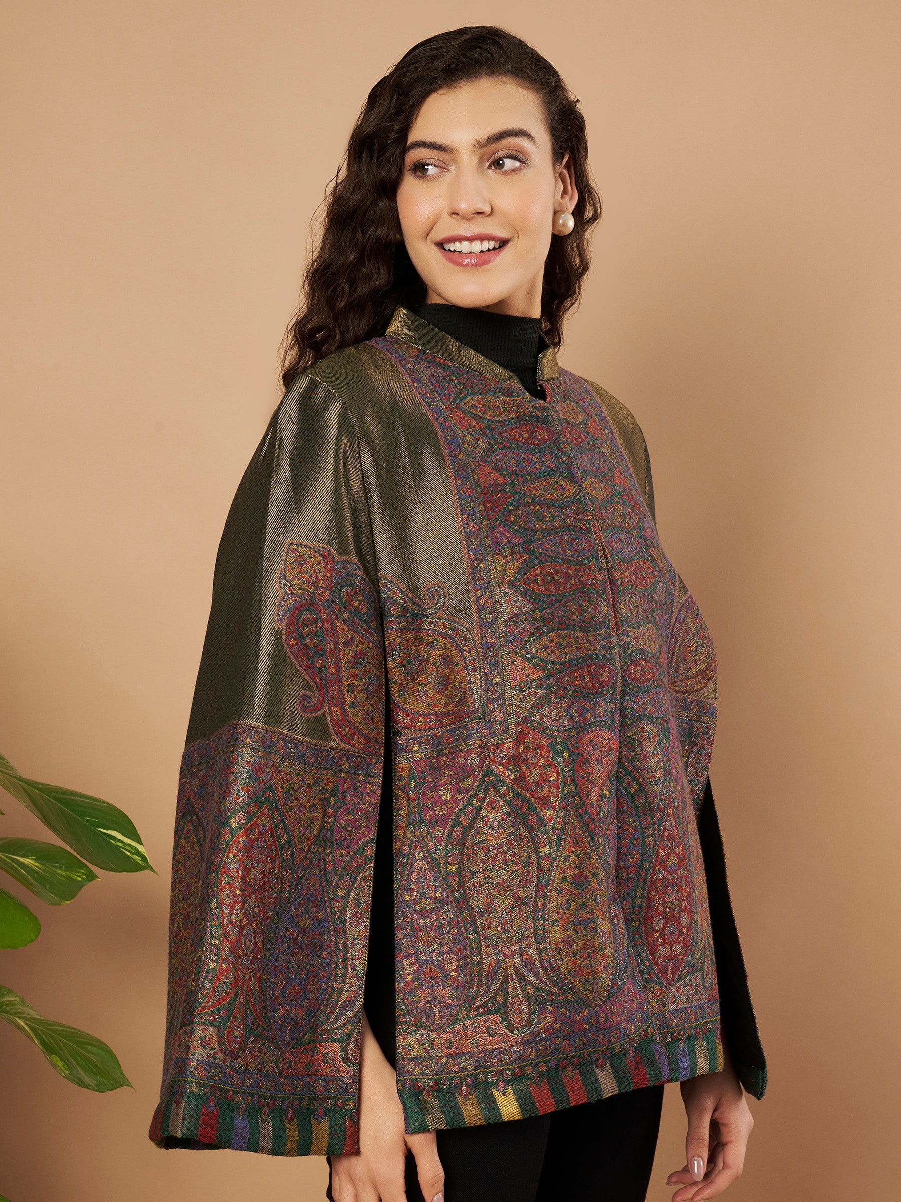 Woman wearing the Falak Moonlight Kaani Cape Jacket with intricate Kashmiri woven paisley motifs and elegant cape silhouette.