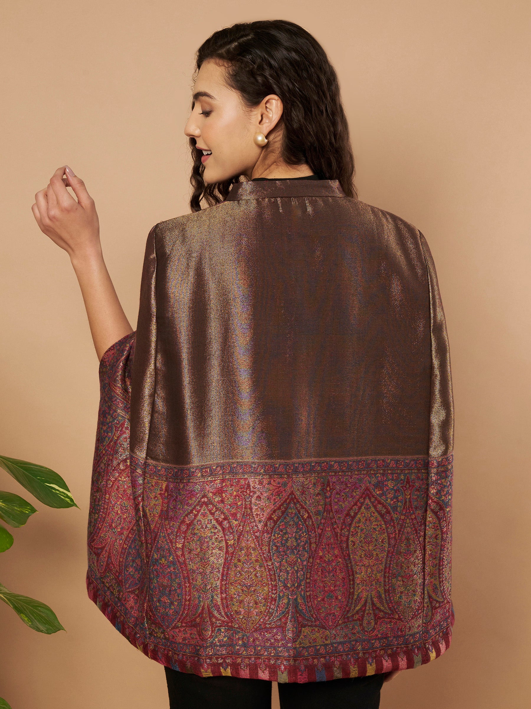 Woman wearing the Maira Moonlight Kaani Cape Jacket with intricate Kashmiri paisley weave and elegant cape silhouette.