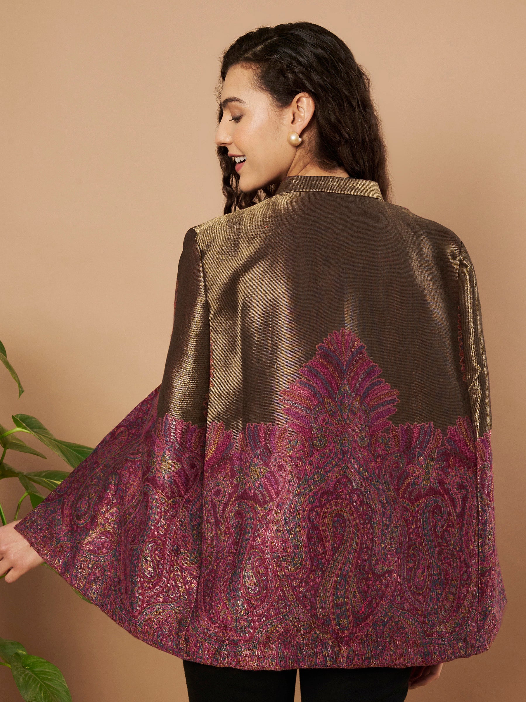 Woman wearing the Zaynah Moonlight Kaani Cape Jacket with intricate paisley Kaani weave and elegant structured cape silhouette.