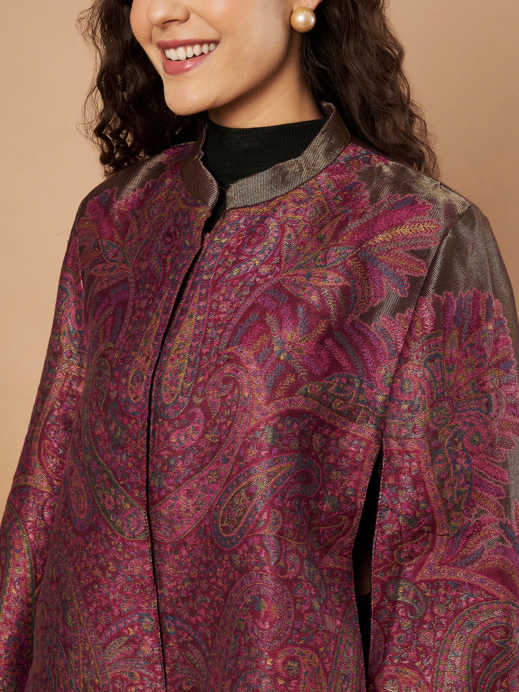 Woman wearing the Zaynah Moonlight Kaani Cape Jacket with intricate paisley Kaani weave and elegant structured cape silhouette.