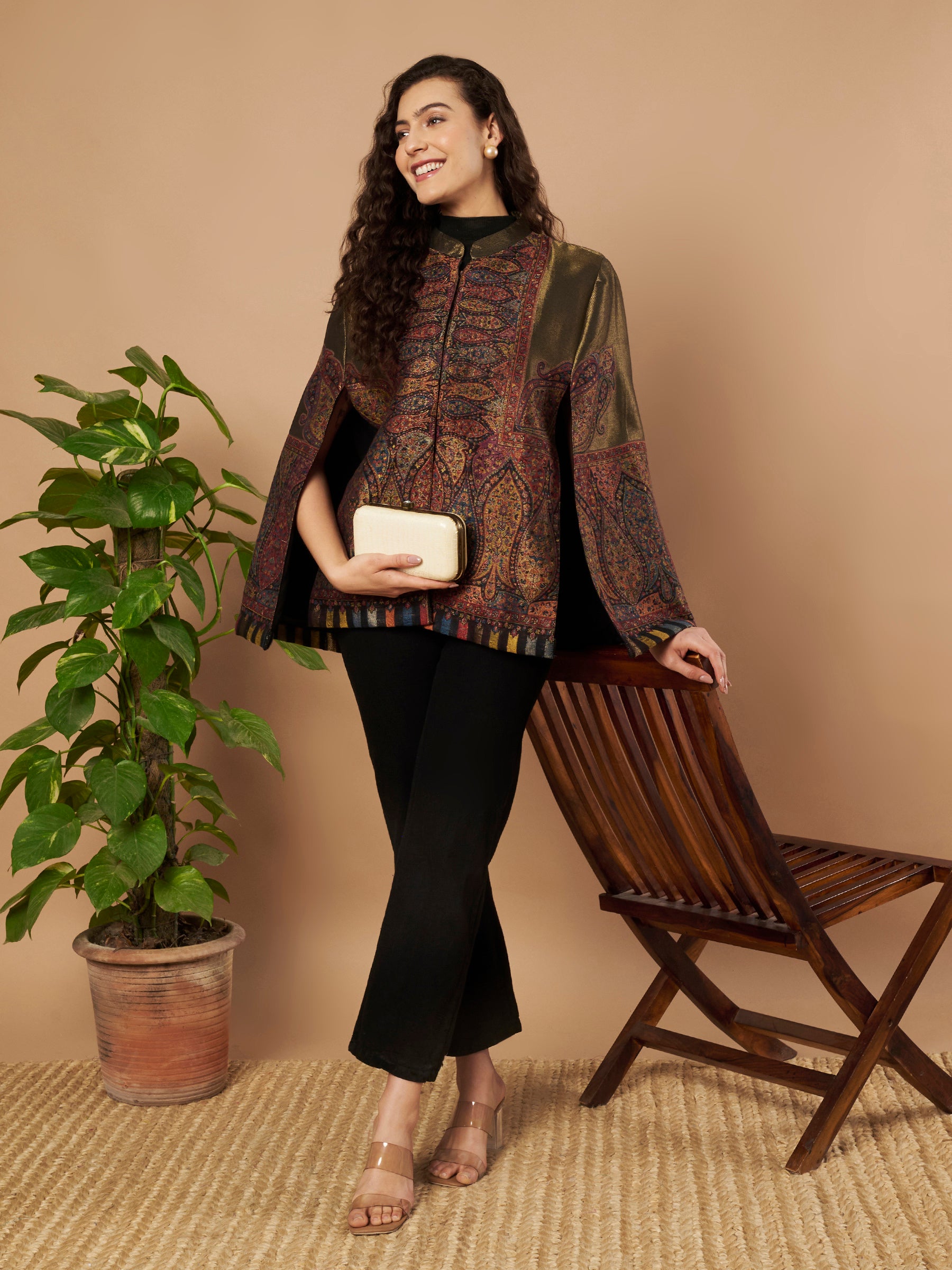 Woman wearing the Shaza Moonlight Kaani Cape Jacket with intricate Kashmiri paisley weave and elegant structured cape silhouette.
