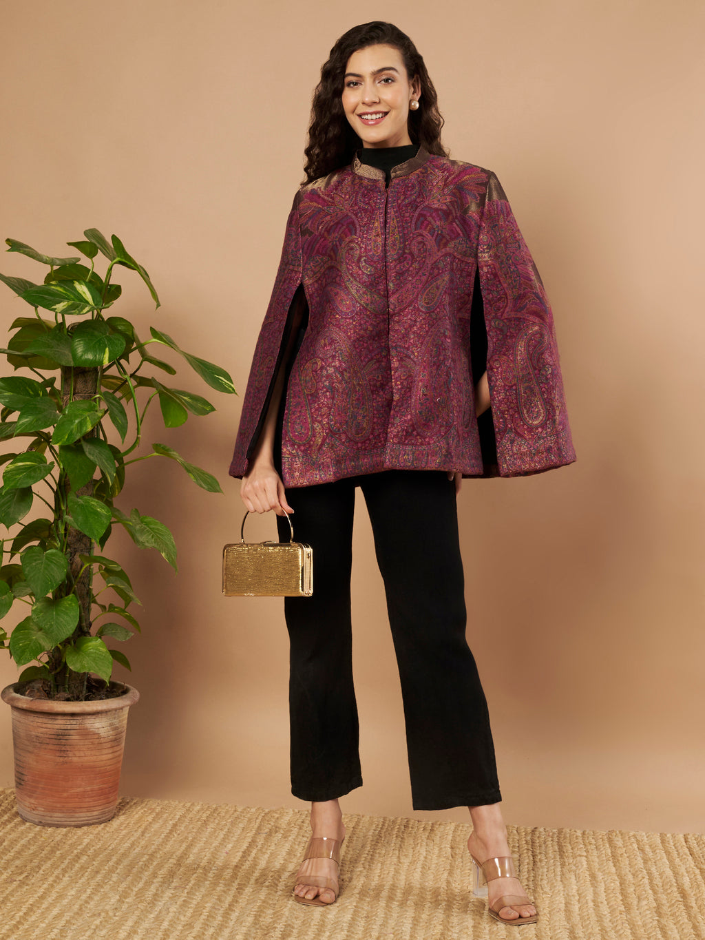 Woman wearing the Zaynah Moonlight Kaani Cape Jacket with intricate paisley Kaani weave and elegant structured cape silhouette.