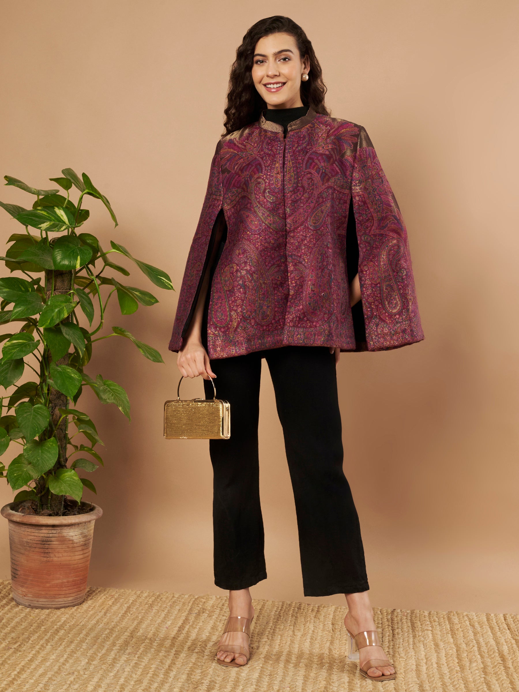 Woman wearing the Zaynah Moonlight Kaani Cape Jacket with intricate paisley Kaani weave and elegant structured cape silhouette.